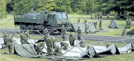  ?? GRAHAM HUGHES/THE CANADIAN PRESS ?? Members of the Canadian armed forces erect tents to house asylum seekers Wednesday the Canada-United States border in Lacolle, Que.