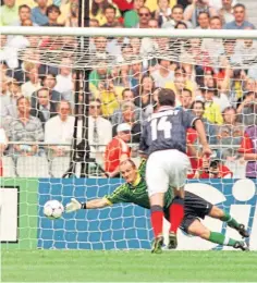  ??  ?? John Collins scores from the penalty spot to bring Scotland level in the opener with Brazil.