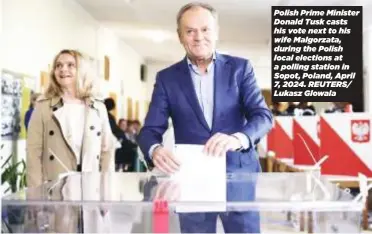  ?? ?? Polish Prime Minister Donald Tusk casts his vote next to his wife Malgorzata, during the Polish local elections at a polling station in Sopot, Poland, April 7, 2024. REUTERS/ Lukasz Glowala