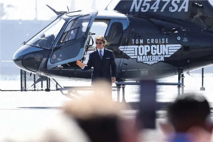  ?? ?? FILE PHOTO: Cast member Tom Cruise waves as he arrives at the global premiere for the film Top Gun: Maverick on the USS Midway Museum in San Diego, California, U.S., May 4, 2022. Image: Reuters