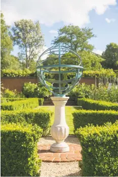  ?? Clive Nichols / Associated Press ?? British designer David Harber's armillary spheres come in bronze, steel or brass. Below, his Torus sculpture, in highly polished steel.