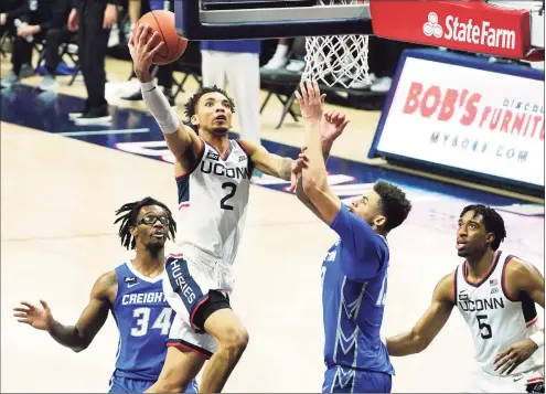  ?? David Butler II / Pool Photo via AP ?? UConn’s James Bouknight drives the ball to the basket against Creighton in the second half on Sunday. Bouknight scored 40 points, but the Huskies fell 76-74 in overtime.