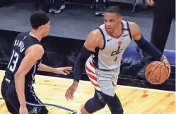  ?? KIM KLEMENT/USA TODAY SPORTS ?? Wizards guard Russell Westbrook (4) drives to the basket as Magic guard R.J. Hampton (13) defends on Wednesday.