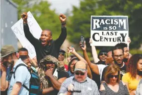  ?? THE ASSOCIATED PRESS ?? Demonstrat­ors protest against a neo-Nazi rally in Newnan, Ga., Saturday.