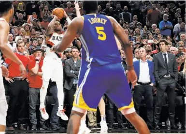  ??  ?? Warriors owner Joe Lacob and GM Bob Myers (far right) watch Portland’s Damian Lillard miss a late shot.