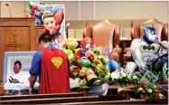  ?? AP PHOTO BY KEN RUINARD ?? In this 2016 file photo, Dale Hall, dressed as Superman, stands before the casket during a superherot­hemed funeral service for his brother, Jacob Hall at Oakdale Baptist Church, in Townville, S.C.