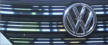  ?? PHOTO: BLOOMBERG ?? A VW badge sits on the grille of a VW BUDD-E concept electric vehicle in the Volkswagen pavilion at the CeBIT 2017 tech fair in Hannover, Germany, last Sunday. VW is singled out by the writer, saying that Volkswagen’s compensati­on system for its top...