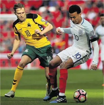  ??  ?? LION-HEARTED: Dele Alli and Lithuania’s Arturas Zulpa