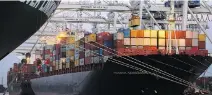  ?? STEPHEN B. MORTON/AP ?? Cranes stack shipping containers on-board a container ship at the Port of Savannah in Savannah, Ga., last month.