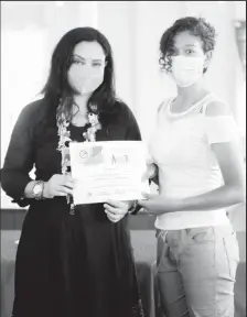  ??  ?? Minister Vindhya Persaud (left) handing out a certificat­e