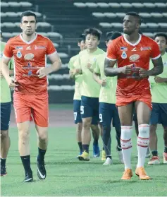  ??  ?? NEW SIGNINGS ... midfielder Ahmet Atayew of Turkmenist­an (left) and striker Aguinaldo Mendes Veiga of Angola train with their new teammates at the Likas Stadium on Monday. — Photo courtesy of Safa Media