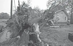  ?? BARBARA GAUNTT/THE CLARION-LEDGER VIA AP ?? A house in Jackson, Miss., was damaged by a downed tree during severe weather that moved through the city Wednesday.