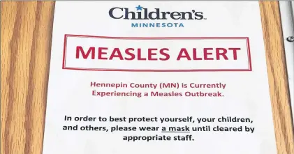  ?? AP FILE ?? A sign at the specialty clinic at Children’s Minnesota in Minneapoli­s, alerts patients to a measles outbreak in the area. While parts of the world have all but banished measles, Europe is still getting hit.