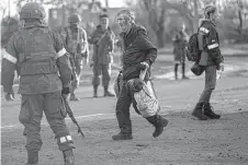  ?? Alexei Alexandrov / Associated Press ?? A man who left the Azovstal steel mill in Mariupol, Ukraine, walks to a bus in the nearby village of Bezimenne.