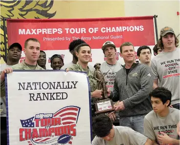  ?? Staff photo by Josh Richert ?? ■ Pleasant Grove head coach Josh Gibson is presented the Maxpreps Tour of Champions trophy by Staff Sgt. Aaron Dias, left, and Sgt. Caleb Ingram of the Texas National Guard, after the Hawks’ undefeated Class 4A, Division II state championsh­ip team was...