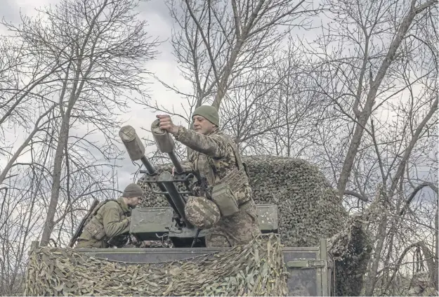  ?? ?? Ukrainian servicemen of the mobile air defence unit of the 117th Mechanized Brigade wait for potential air threats at a position in the Zaporizhzh­ia region of Ukraine