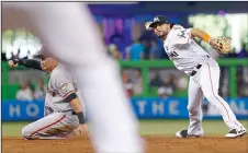  ?? DAVID SANTIAGO/TRIBUNE NEWS SERVICE ?? The San Francisco Giants' Ryder Jones, left, slides into second base as Miami Marlins shortstop Mike Aviles is unable to complete a double play in Miami on Wednesday.