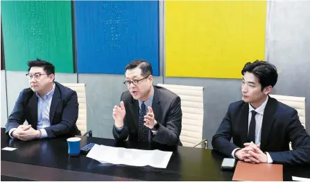  ?? Courtesy of Yulchon ?? Yulchon’s Head of IP & Technology Practice Group Son Do-il, center, speaks during an interview with The Korea Times at the law firm’s headquarte­rs in southern Seoul, March 6. From left, Head of New Industry IP Team Lim Hyeong-joo, Son, and Lee Han-kyeol, associate and patent attorney at the firm.