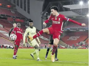  ?? (Photo: AFP) ?? Liverpool’s English midfielder Curtis Jones (right) scores the opening goal during the UEFA Champions League first-round Group D football match between Liverpool and Ajax at Anfield in Liverpool, northwest England yesterday.