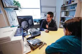  ?? Associated Press file ?? Alison Cairnes views images with her doctor, Shumei Kato, at the University of California in San Diego. Tumor profiling Cairnes’ cancer genes helped Kato identify an effective treatment for her gastric cancer.