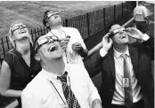  ?? PHOTO: REUTERS ?? Members of the media watch the solar eclipse at the White House in Washington, on Monday