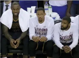  ?? BEN MARGOT - THE ASSOCIATED PRESS ?? Cleveland Cavaliers forward LeBron James, from left, sits on the bench with center Tristan Thompson and guard Kyrie Irving during the second half of Game 1 of the NBA Finals against the Golden State Warriors Thursday in Oakland, Calif.