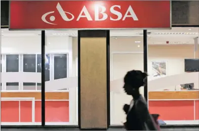  ?? PHOTO: REUTERS ?? A woman walks past a branch of Barclay’s South African subsidiary Absa bank in Cape Town. Barclays Africa shares dropped as much as 2.1 percent on Friday after a leaked report by the Public Protector that the bank had from 1985 to 1995 received a...