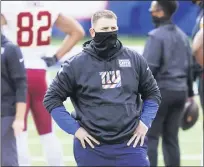  ?? JOHN MINCHILLO — THE ASSOCIATED PRESS ?? New York Giants head coach Joe Judge watches his team warm up before an NFL football game against the Washington Football Team Sunday, Oct. 18, 2020, in East Rutherford, N.J.