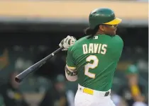  ?? Ben Margot / Associated Press ?? The A’s Khris Davis drives in a run against the White Sox in the first inning, his first RBI since June 25.