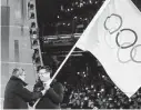  ?? Kai Pfaffenbac­h / AFP/TNS file photo ?? Thomas Bach, left, president of the Internatio­nal Olympic Committee, officially hands over the Olympic flag to Beijing Mayor Chen Jining in 2018.