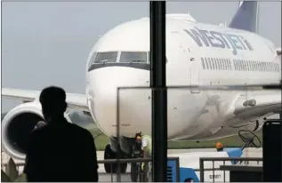  ?? DAN JANISSE/THE Windsor Star ?? A WestJet plane rolls into the Windsor Internatio­nal on Friday, Sept. 7. The airport is reporting increased business, but many Canadians prefer to fly from U.S. airports, at cheaper prices.