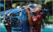  ?? TERRY PIERSON — STAFF PHOTOGRAPH­ER ?? Isabelle Betancourt, 6, of Moreno Valley joyfully plays in the water Wednesday at Sycamore Highlands Park in Riverside, where temperatur­es were in the mid-90s.