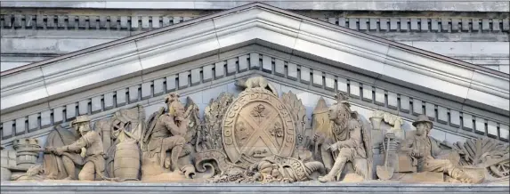  ?? JOHN KENNEY/ THE GAZETTE ?? The pediment atop the Bank of Montreal building in Old Montreal depicts Montreal’s crest, featuring symbols of Scotland, Ireland, England and French Canada, and two natives.