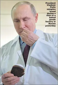  ??  ?? President Vladimir Putin samples bread during a visit to a baked goods factory in Russia yesterday