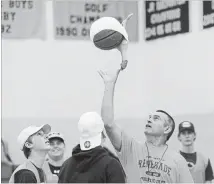  ?? PETER LEE WATERLOO REGION RECORD ?? Grand River Collegiate phys-ed teacher Steve Peng tosses the ball into the air for the tipoff of a game of rubber chicken basketball on Tuesday. Attaching the comical prop to the ball is intended is to make the game fun for everyone and eliminate the advantage skilled players have.