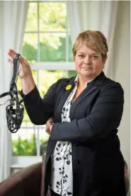  ?? STEPHANIE AMADOR / THE TENNESSEAN ?? Dr. Michelle Fiscus holds a muzzle at her home in Franklin, Tenn., in July. The former top vaccinatio­n official was fired from the Tennessee Department of Health. “Whoever sent that must not know me very well. That’s for a beagle, but I’m a pit bull,’” Fiscus said.