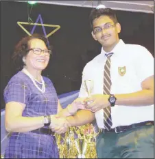  ??  ?? Khishan Singh receiving a prize from First Lady Sandra Granger at the Bishops’ High School Prize Giving ceremony earlier this year.