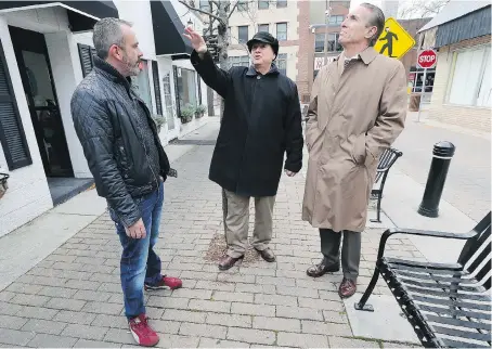  ?? DAN JANISSE ?? John Ansell, left, co-owner of the Squirrel Cage, speaks with Larry Horwitz, centre, chair of the DWBIA and Peter Bellmio, a criminal justice management consultant on Monday. Bellmio has been hired by the DWBIA to study and report on the public safety issues in the downtown core.