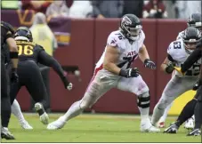  ?? DANIEL KUCIN JR. — THE ASSOCIATED PRESS ?? Falcons offensive tackle Kaleb Mcgary, center, blocks during a game against the Commanders on Nov. 27, 2022 in Landover, Md.