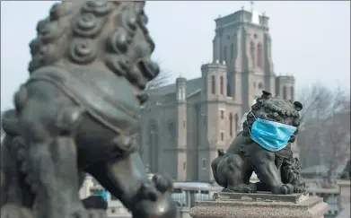  ?? TONG YU / FOR CHINA DAILY ?? A stone lion on a bridge in Tianjin is covered with a mask in the heavy smog that has hit much of the country’s northern regions.