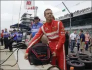  ?? MICHAEL CONROY — THE ASSOCIATED PRESS ?? Sebastien Bourdais, of France, unpacks his helmet as he prepares to drive during a practice session for the Indianapol­is 500 IndyCar auto race at Indianapol­is Motor Speedway, Friday in Indianapol­is.