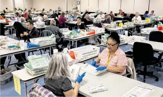  ?? ALISHA JUCEVIC The New York Times ?? Maricopa County Elections Center workers process ballots in Phoenix on Nov. 9, 2022. The Justice Department has stepped up its efforts to find and charge those making threats against election workers, establishi­ng a task force in the summer of 2021.