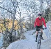  ??  ?? Pam LeBlanc takes a bike tour of Cameron Park. The Waco attraction includes 20 miles of trails.