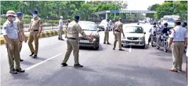  ?? P.SURENDRA ?? Police stop vehicles plying near Rail Nilayam in Secunderab­ad on Sunday to check if they have a valid reason for being on the road during the lockdown. —