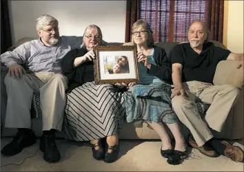  ?? Bill Gorman/Associated Press ?? From left, Patrick Boyle, Linda Boyle, Lyn Coleman and Jim Coleman gather in 2014 in Stewartsto­wn, Pa. They’re holding a photo of their children, Joshua Boyle and Caitlan Coleman, who were kidnapped by the Taliban in late 2012.