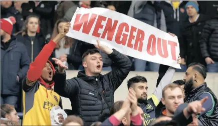  ??  ?? HAD ENOUGH:ARSENAL fans call for manager Arsene Wenger’s exit during yesterday’s 3-1 loss to West Bromwich Albion at the Hawthorns.