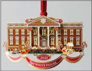  ?? (AP/Pablo Martinez Monsivais) ?? The White House Historical Associatio­n’s 2022 Christmas Ornament is seen Dec. 6 in Washington. The annual tree ornament this year honors President Richard M. Nixon’s administra­tion and a nod to first lady Pat Nixon who first put a gingerbrea­d house on display in the State Dining Room for the holiday season at the White House, long before its talented pastry chefs began making hundredpou­nd replicas of the executive mansion.
