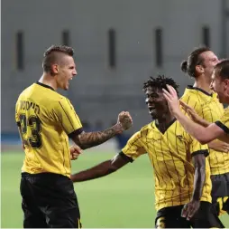  ?? (Adi Avishai) ?? BEITAR JERUSALEM DEFENDER Marcel Heister (left) celebrates with teammates after scoring the winner in last night’s 2-1 victory over Maccabi Petah Tikva in Premier League action.