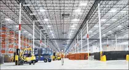 ?? RJRealEsta­te.Vegas file ?? Earlier this year, a crew member walks through constructi­on of the newest Amazon warehouse at Northgate Distributi­on Center in North Las Vegas.