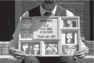  ?? KASSI JACKSON/HARTFORD COURANT ?? Sean Diaz, wearing his wedding outfit, holds photos of his wife, Cassondra Diaz, outside his family’s Hartford home on May 15. Cassondra Diaz, 31, died due to COVID-19 complicati­ons.